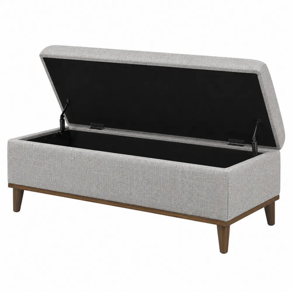 Panca contenitore in tessuto grigio con gambe in legno